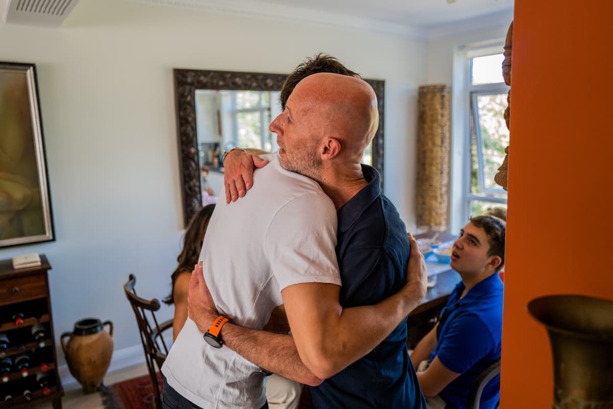 The image is of two men hugging.